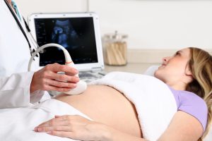 a doctor performing a private ultrasound scan on a woman in London